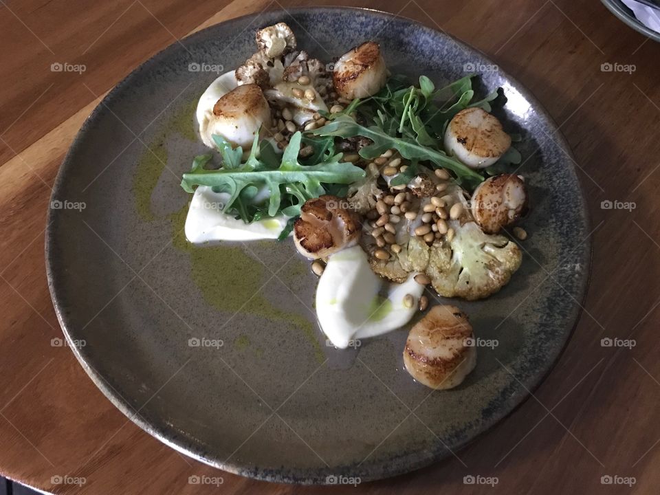 Seared scallops with cauliflower and pine nuts