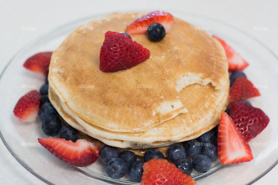 A perfect stack of pancakes but with a bite in one !