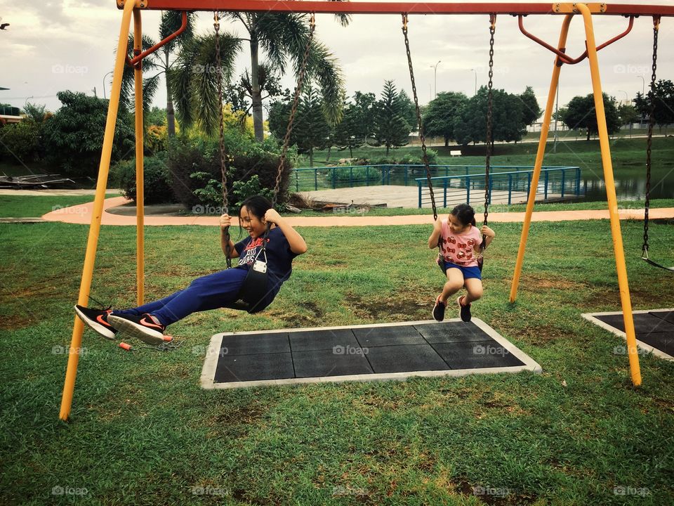 Two kids playing at the park.