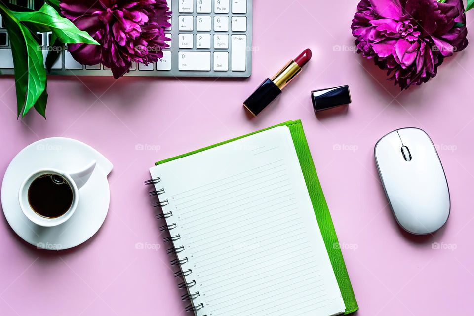 flat lay on pink background cosmetics lipstick flowers peonies and coffee notepad