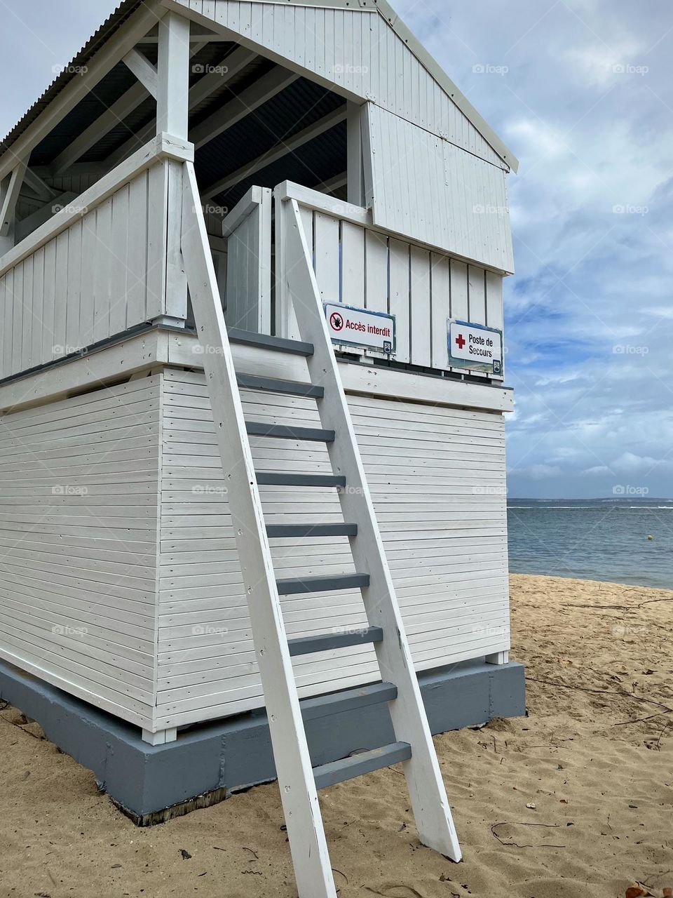 White wooden emergency cabin on a Caribbean sandy beach