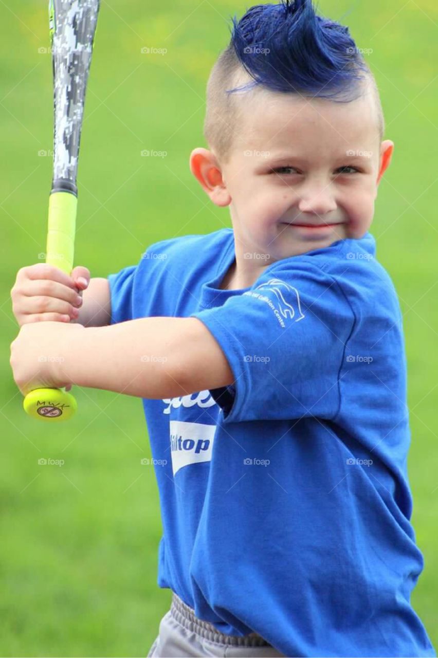 Batter up! My little T-ball player, decked out with his blue shirt and blue hair posing in his best batting stance. 