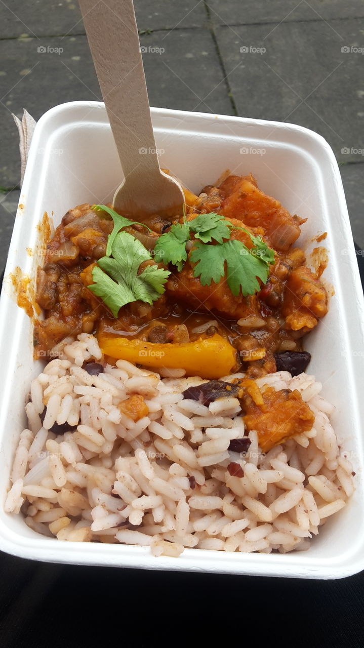 Vegan Jamaican Sweet Potato Curry Rice And Peas In A Take Away Food Tray With Wooden Fork - Street / Festival Food - Healthy