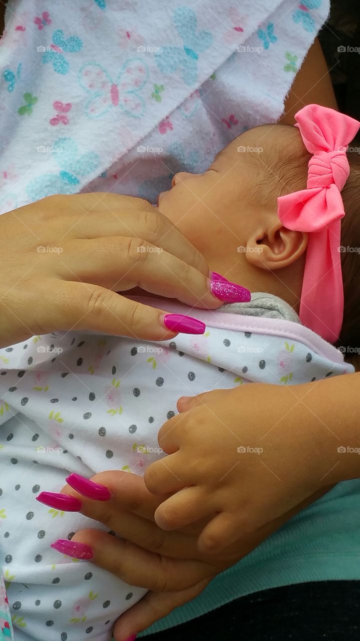 Hands touching newborn baby