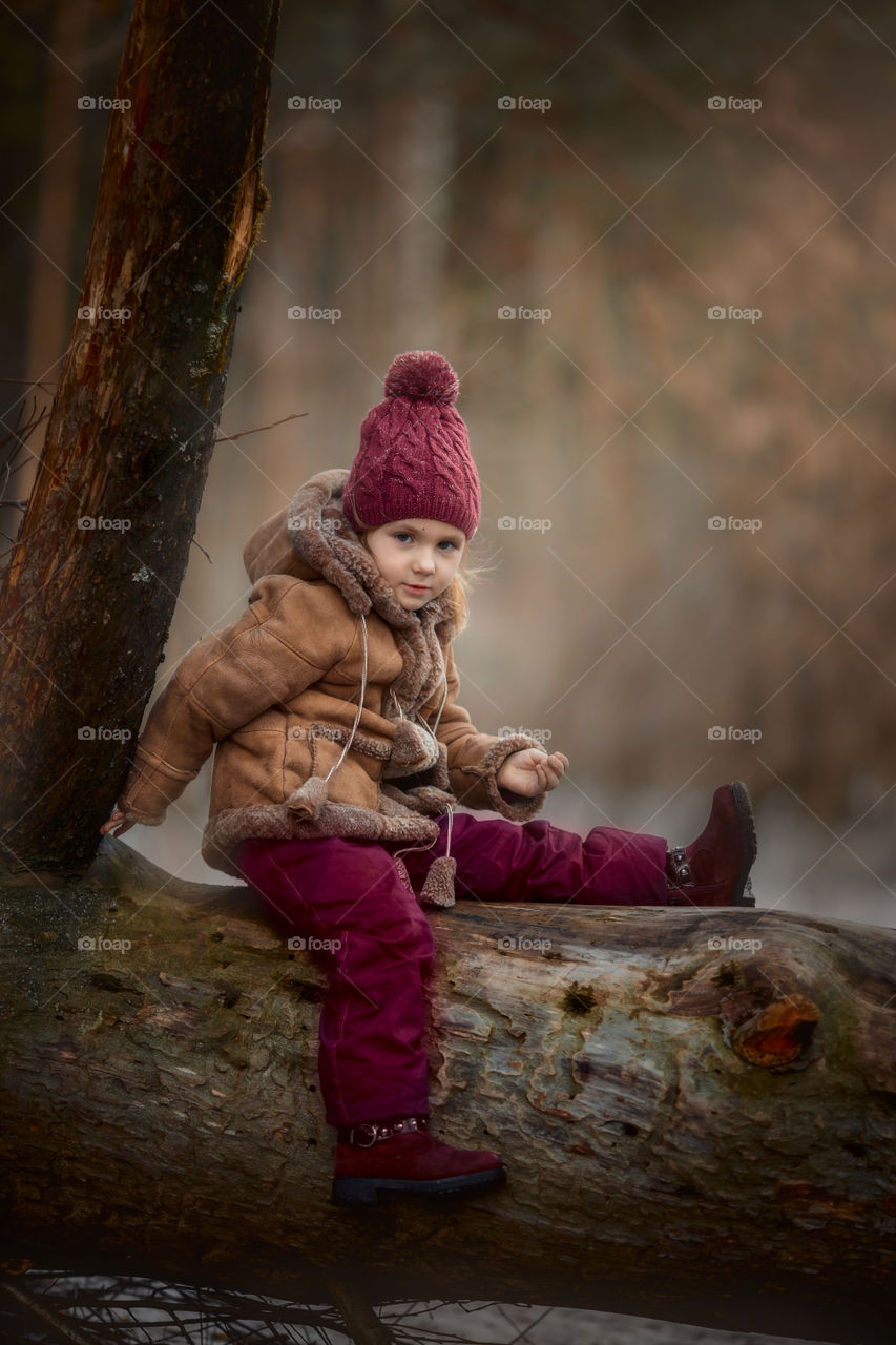 Little girl portrait at early spring forest