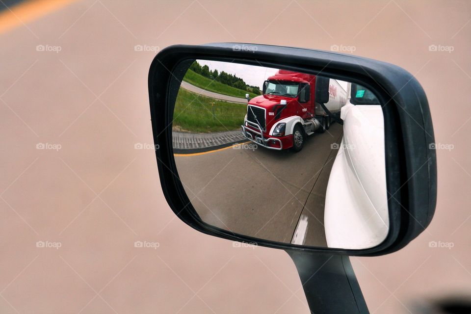 Fast Lane. Volvo truck coming up the passing lane. Captured in the mirror view.