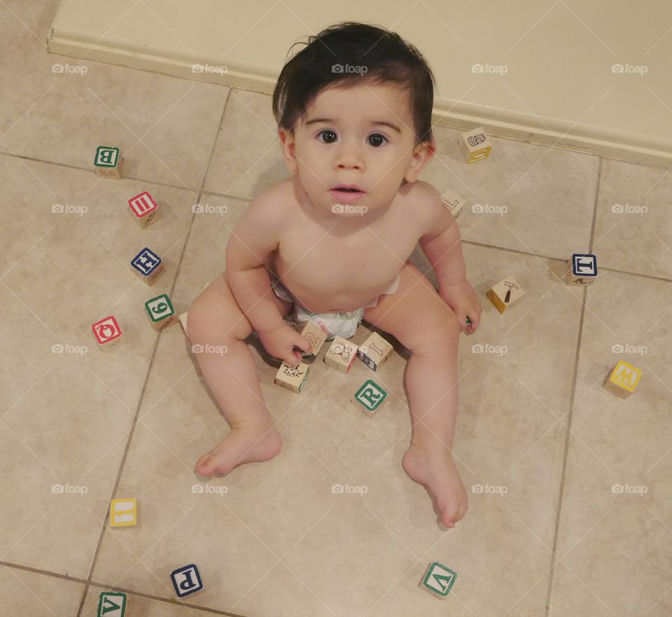 Cute boy playing with wooden blocks