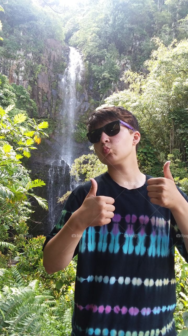 Thumbs up in Maui Hawaii in front of a water fall