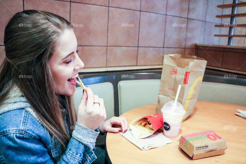 McDonald’s- girl eating at McDonald’s . 