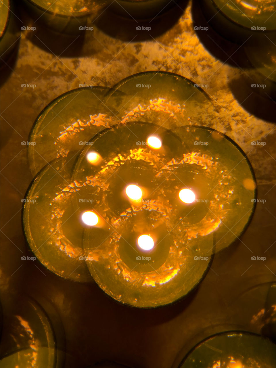 One lit tea lights viewed through a kaleidoscope lens