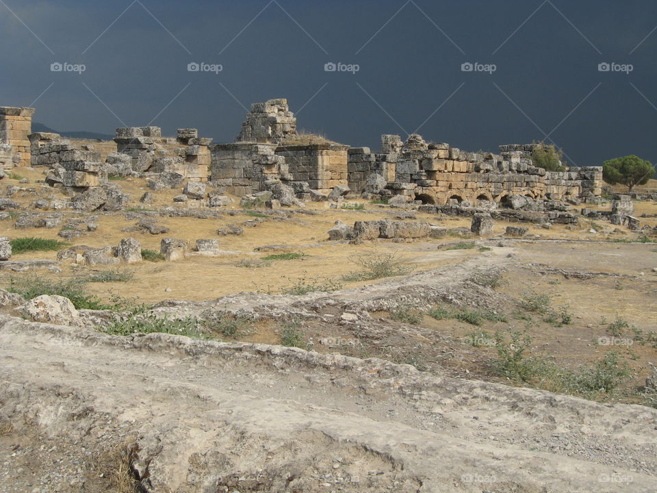 A rain cloud is approaching the ancient ruins.