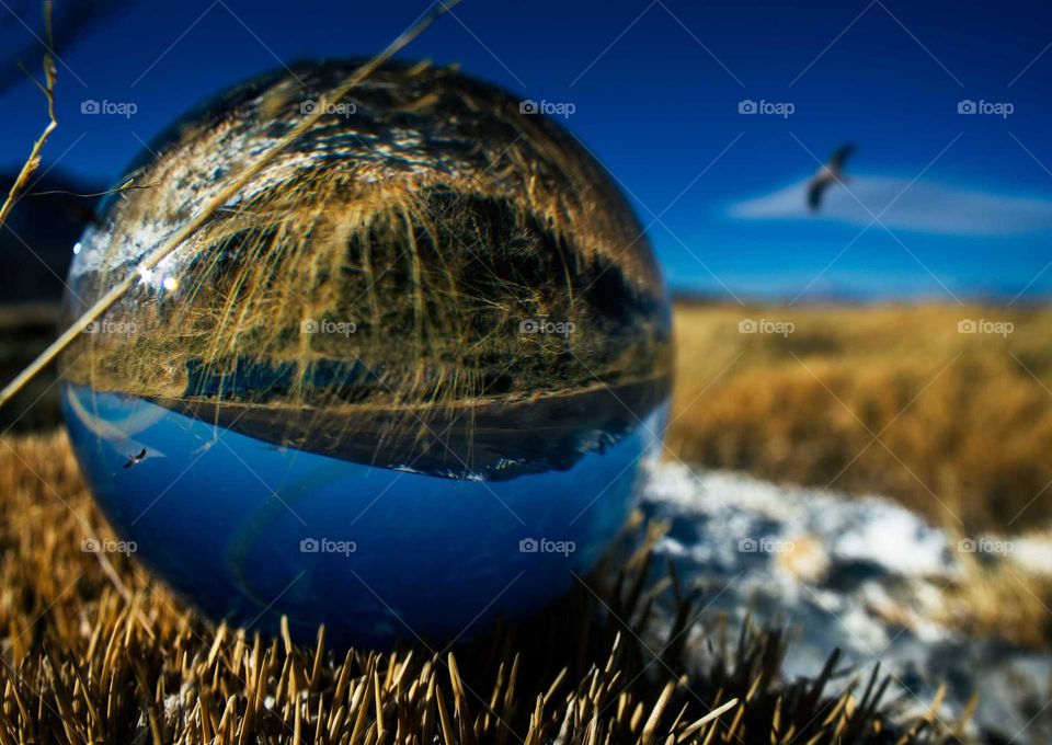 beautiful view of the mountains through a glass sphere