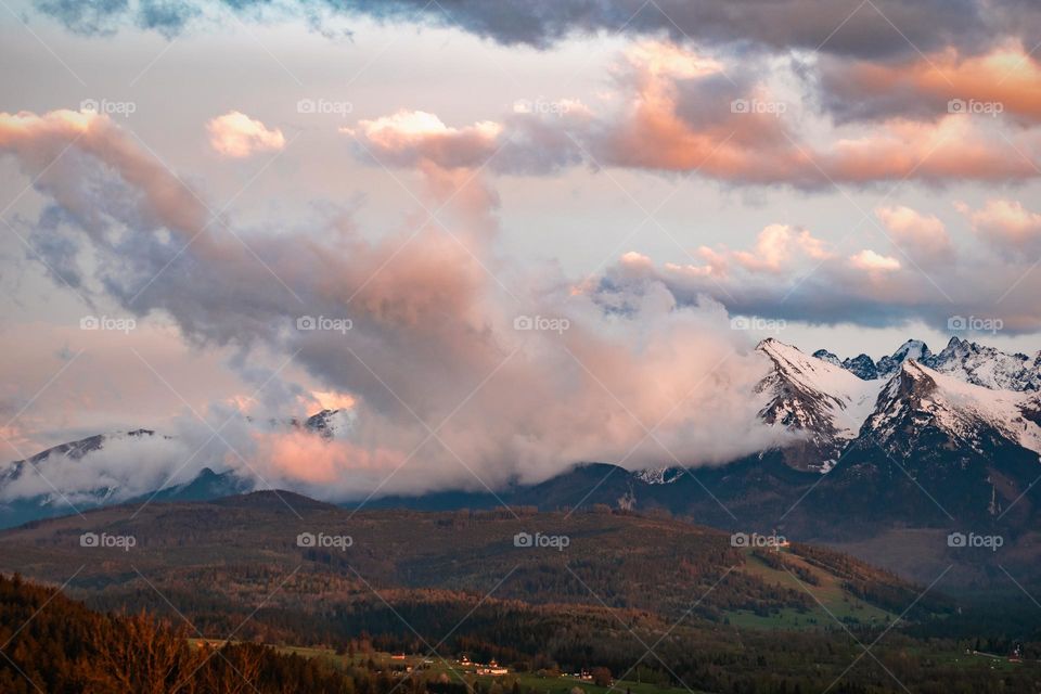 Fog floating in the Tatra Mountains during sunrise.