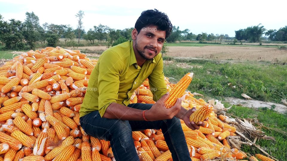 happy farmer with maize