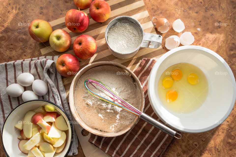 Making homemade puffed apple pie with eggs, sugar and flour.