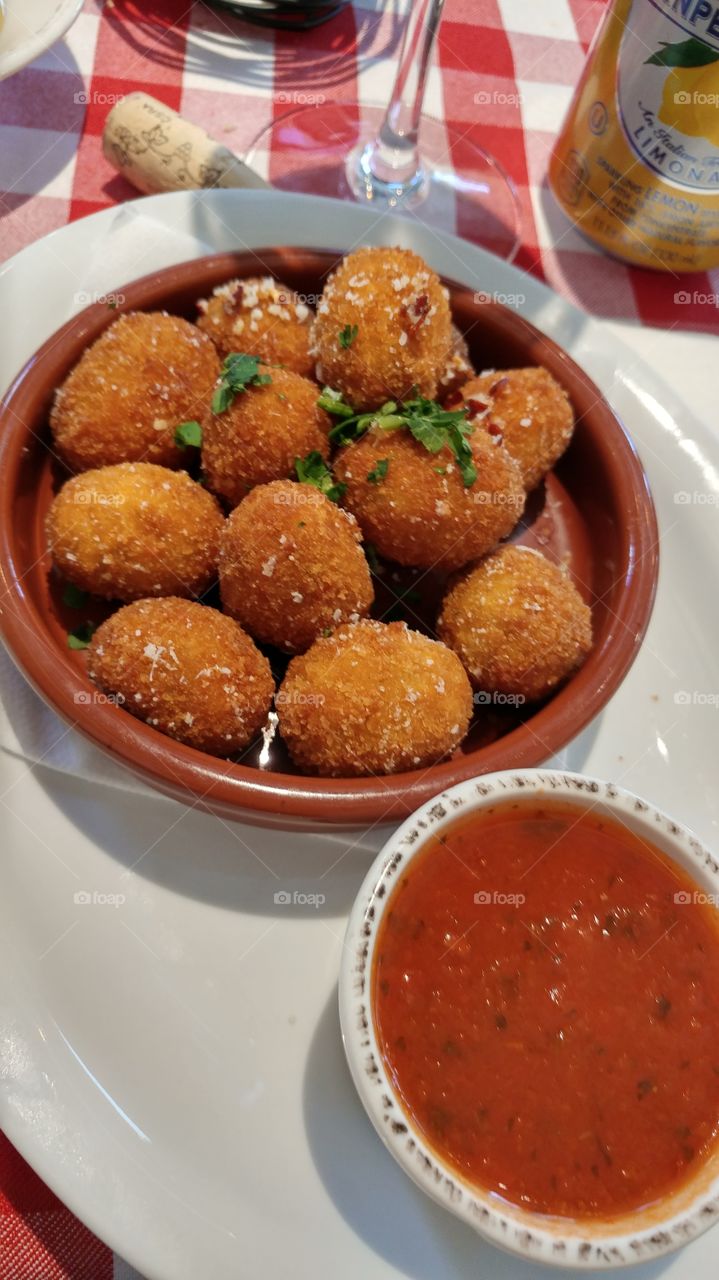 Fried olives with tomato sauce