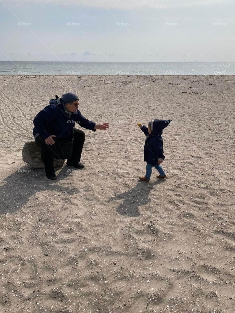 grandmother receives a small flower from grandson