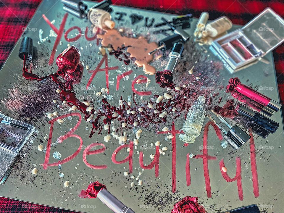 Message written on mirror in lipstick, you are beautiful positive vibes message, messy makeup on mirror, reflections of a makeup mess, makeup brands take a stand, looking in the mirror, recognizing your own beauty, makeup mess on the mirror 