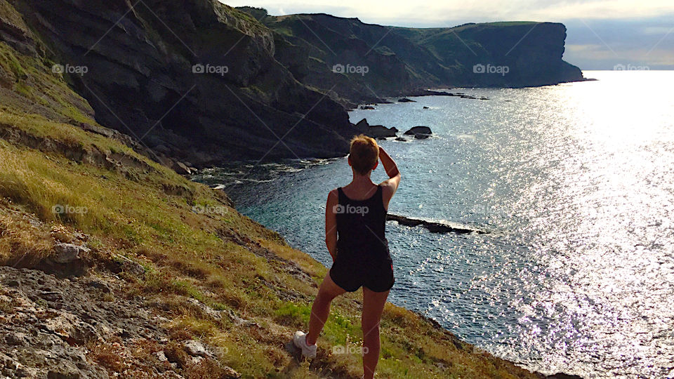 A woman looking at the cliffs at Cantabria, Spain 