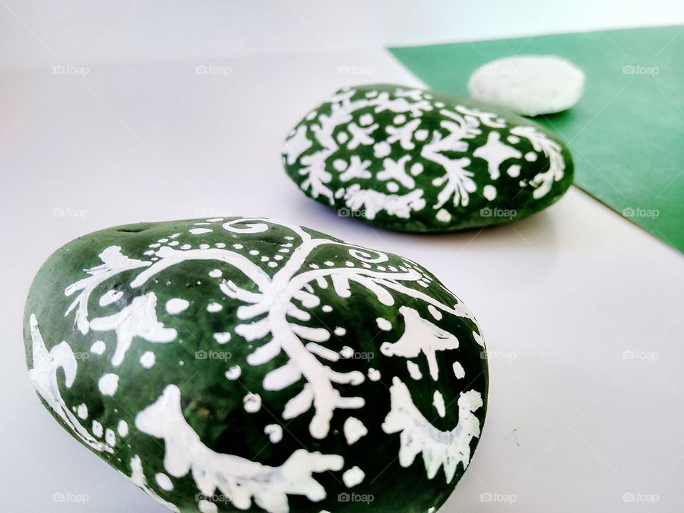 White x green by foaр missions,stones painted with green and white paints covered with painting