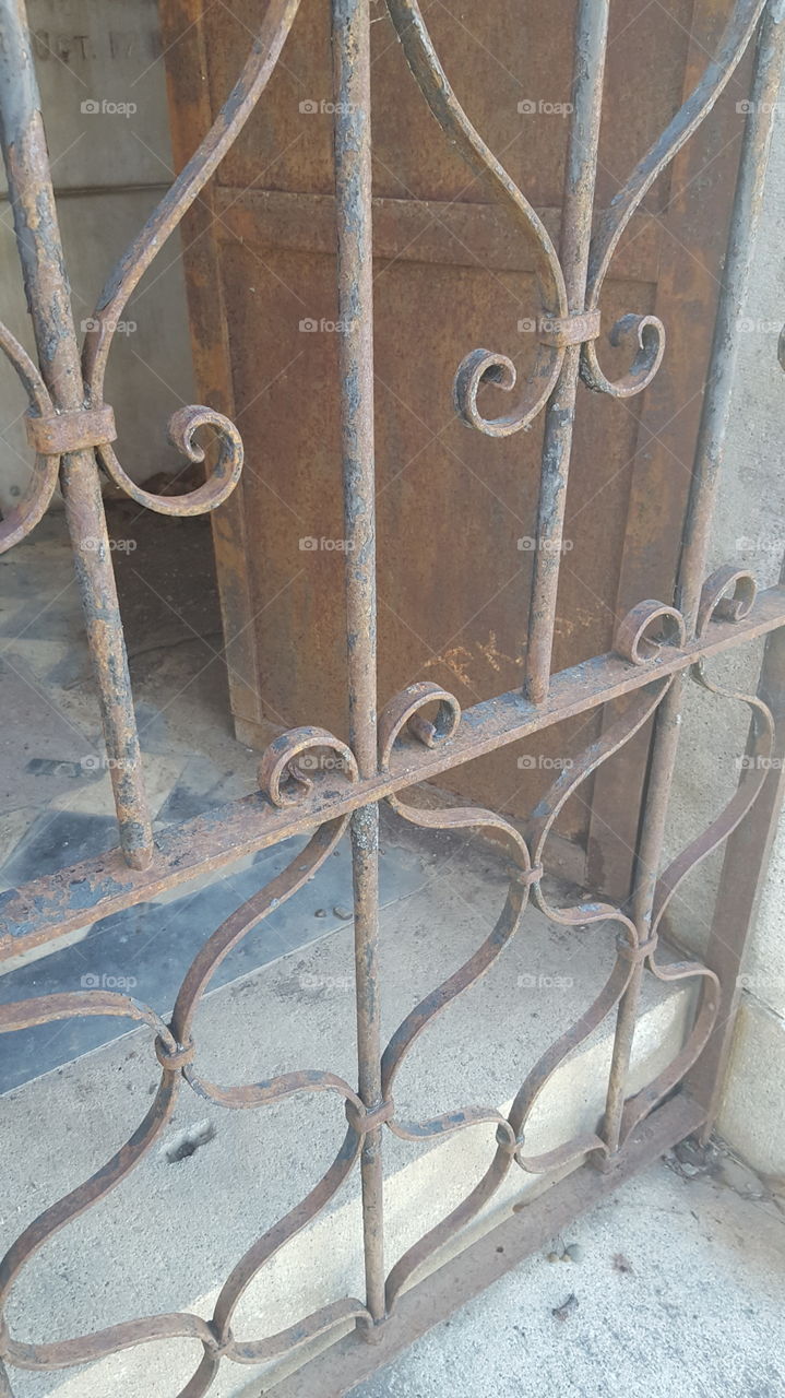 while walking through Oak Hill Cemetery in San Jose I found some of the older family mausoleums open to the elements. doors and gates are rusting away.