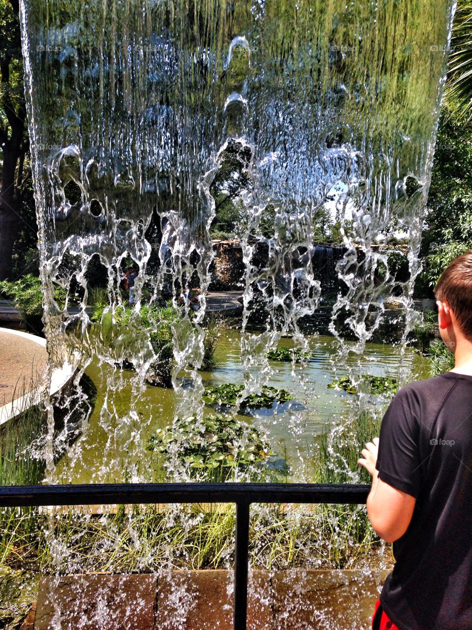 Splash of summer. Waterfall at an outdoor garden exhibit 