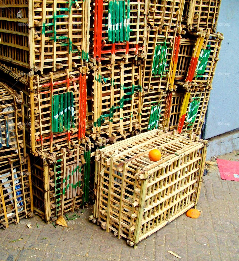 Stacked crates on Egyptian street with green patterns and small orange