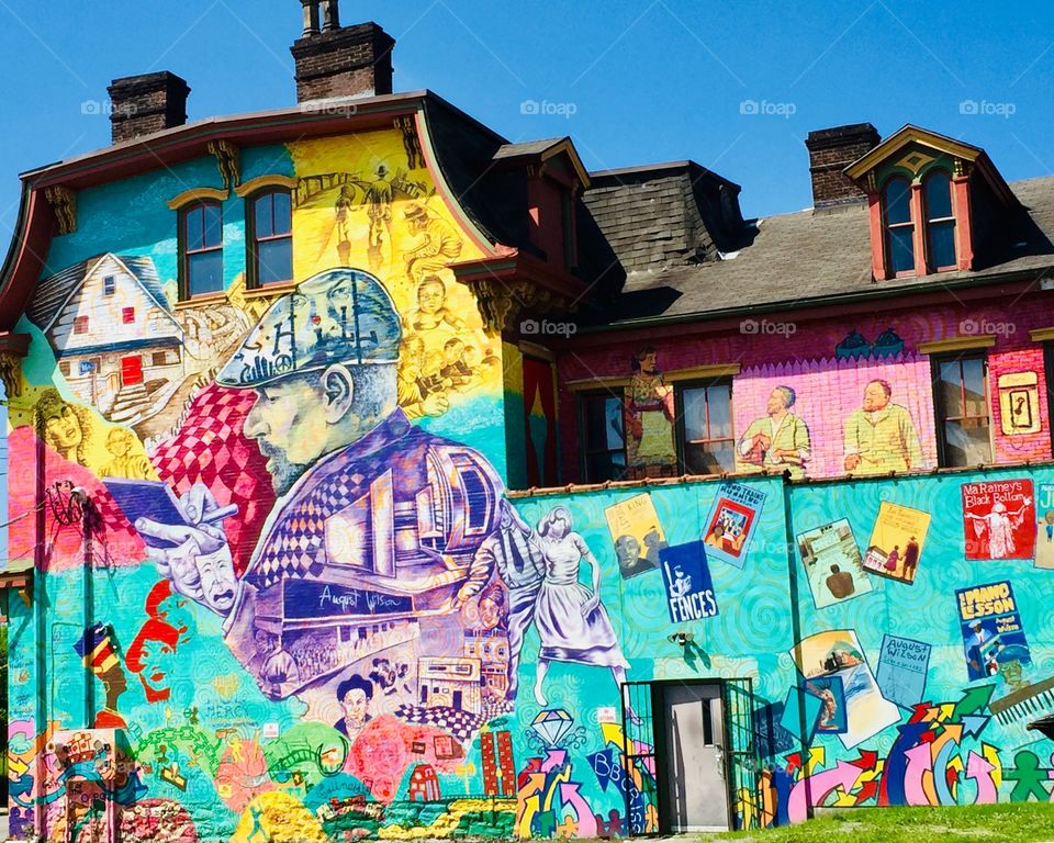 Colorful mural celebrating Pulitzer Prize and Tony Award winning author August Wilson, painted on a building in the Hill District Centre Avenue in Pittsburgh Pa