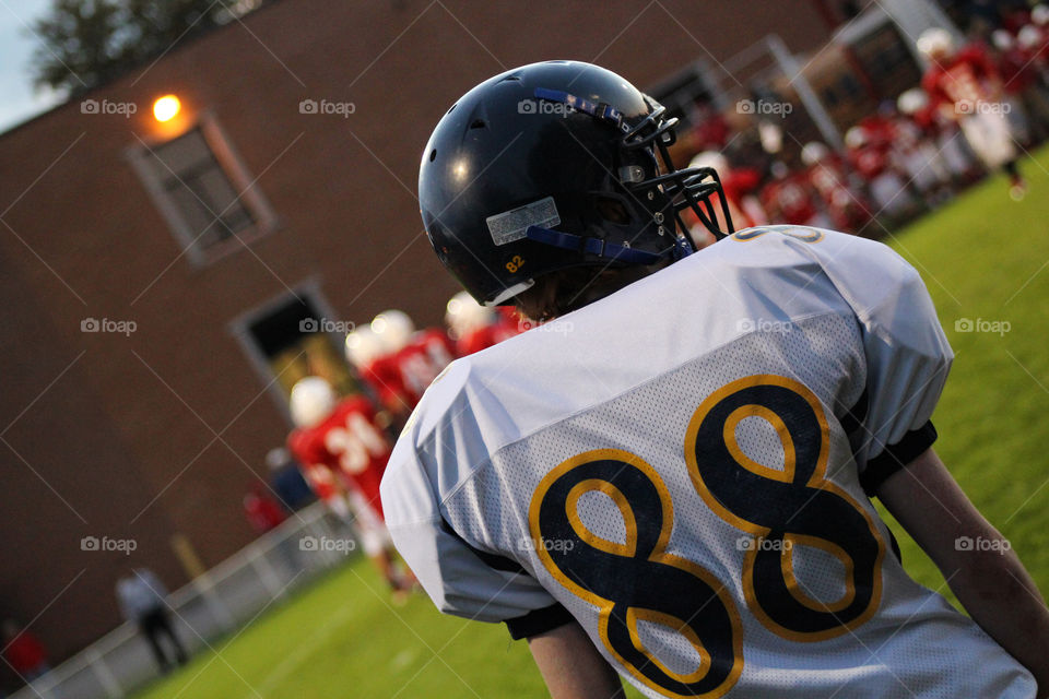 Rear view of American football player 