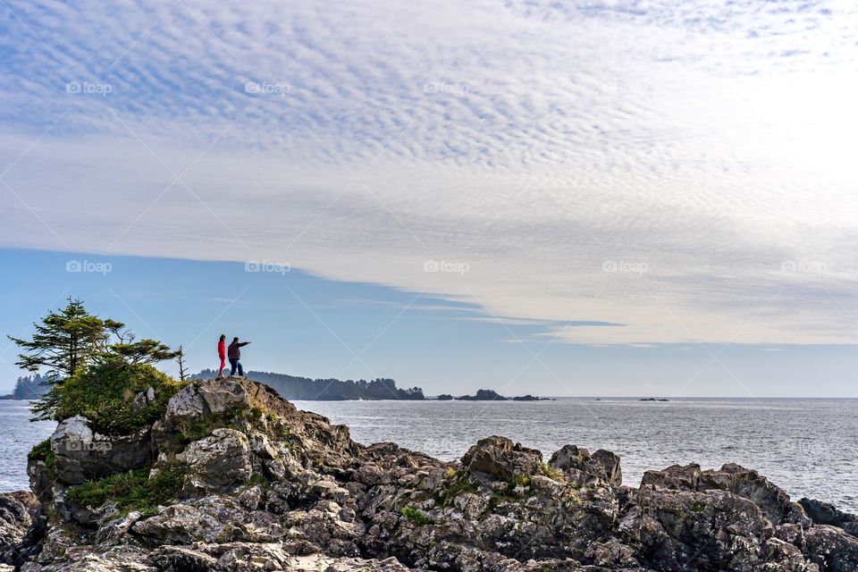 Tourists look out into the vastness of the Pacific Ocean near Tofino, British Columbia, Canada 