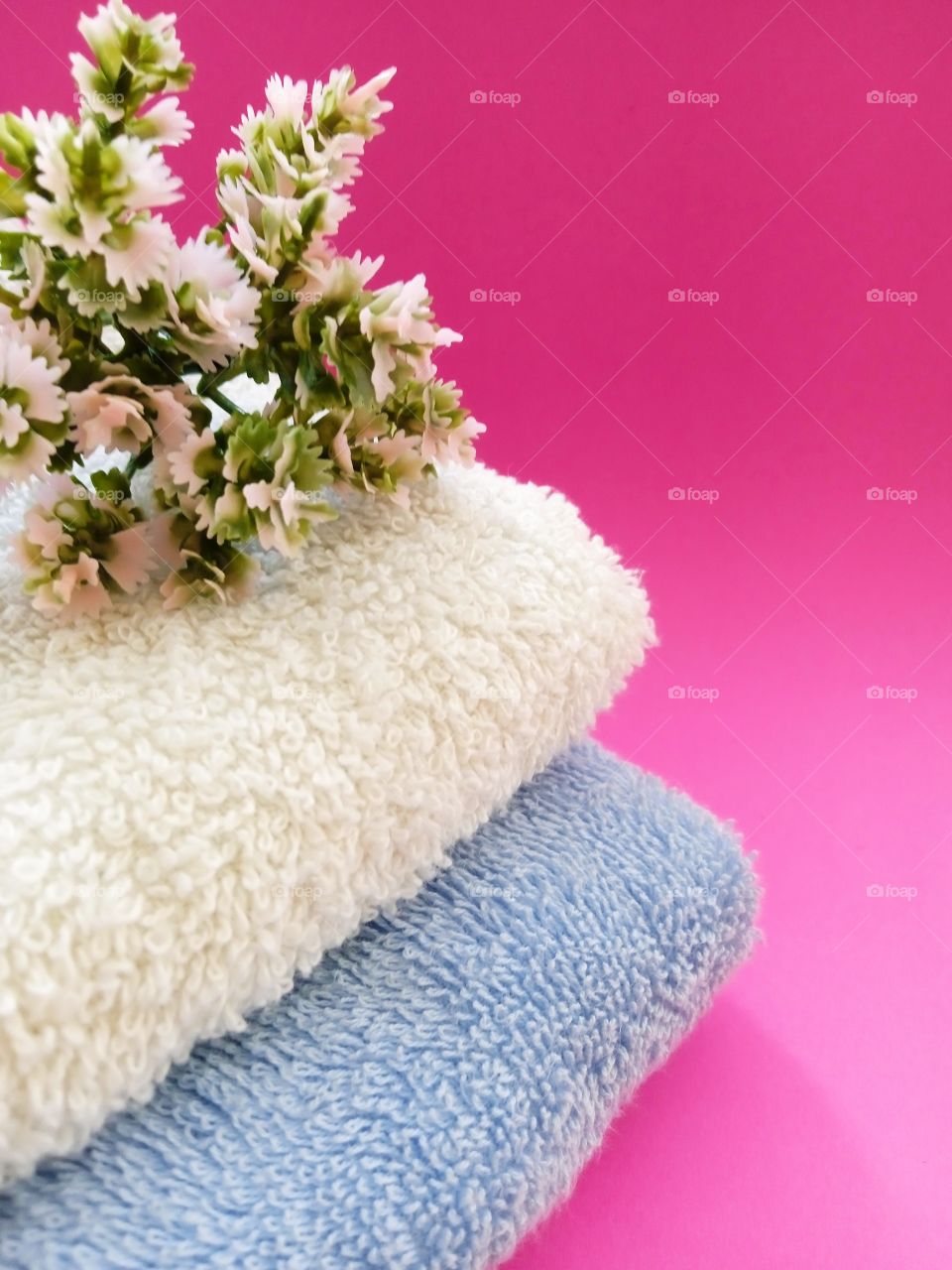 towel on a pink background with twigs