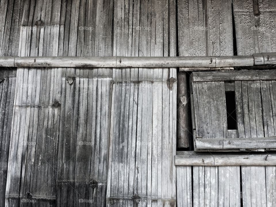 The walls of the house are made from bamboo in a rural area in Thailand.  The rural people built simple houses, looking for natural materials to build houses.