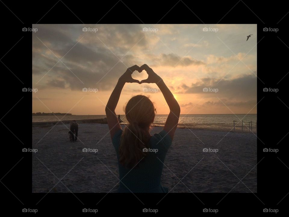 sunrise and hands in heart shape
