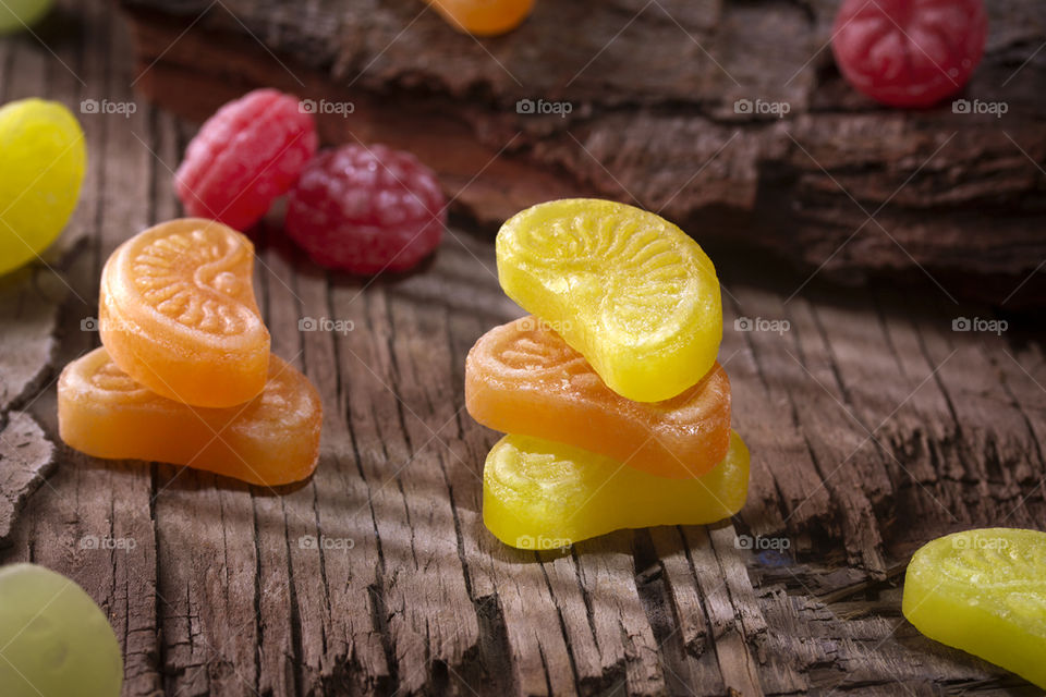 Colored sweets in rustic wood