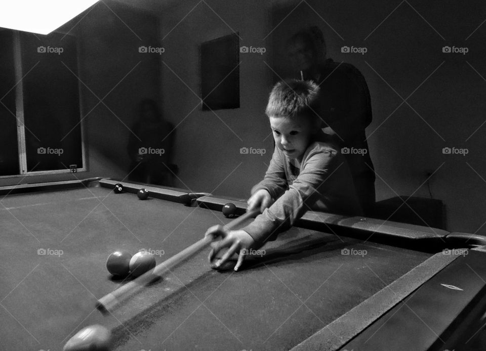 Young Boy Playing Billiards