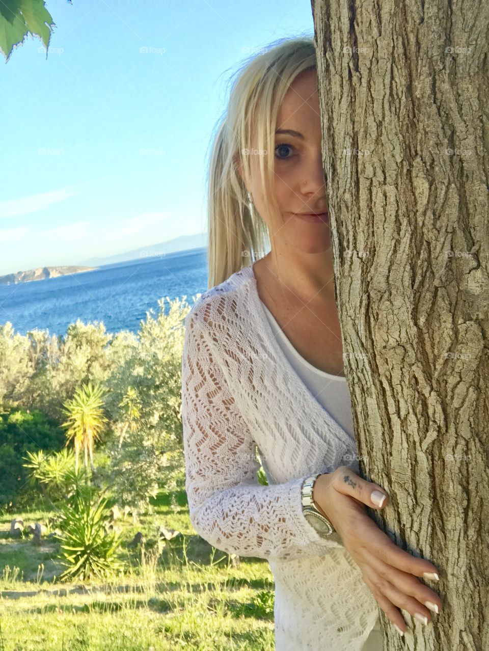 Woman behind a tree