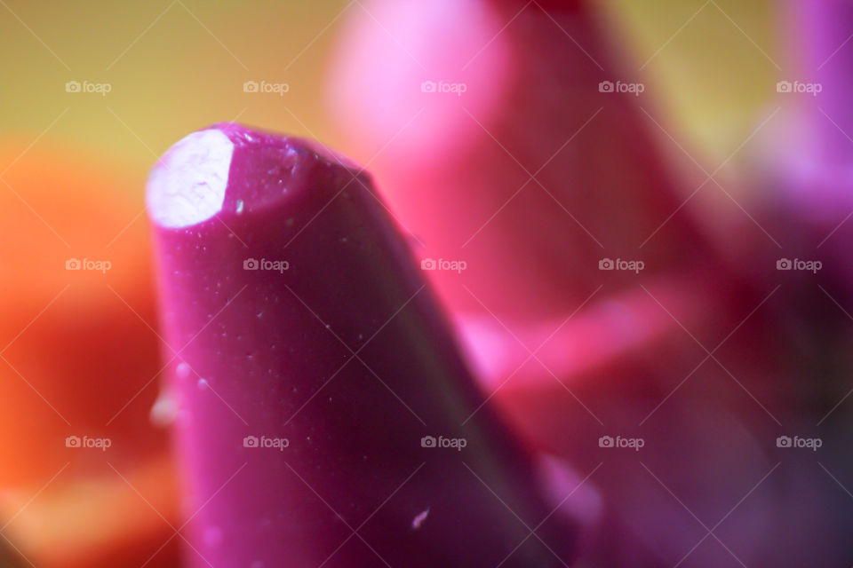 Extreme macro shot of a purple crayon, captured with the technique of inverted photography.