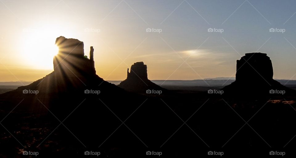 Starburst sunrise over Monument Valley, Arizona