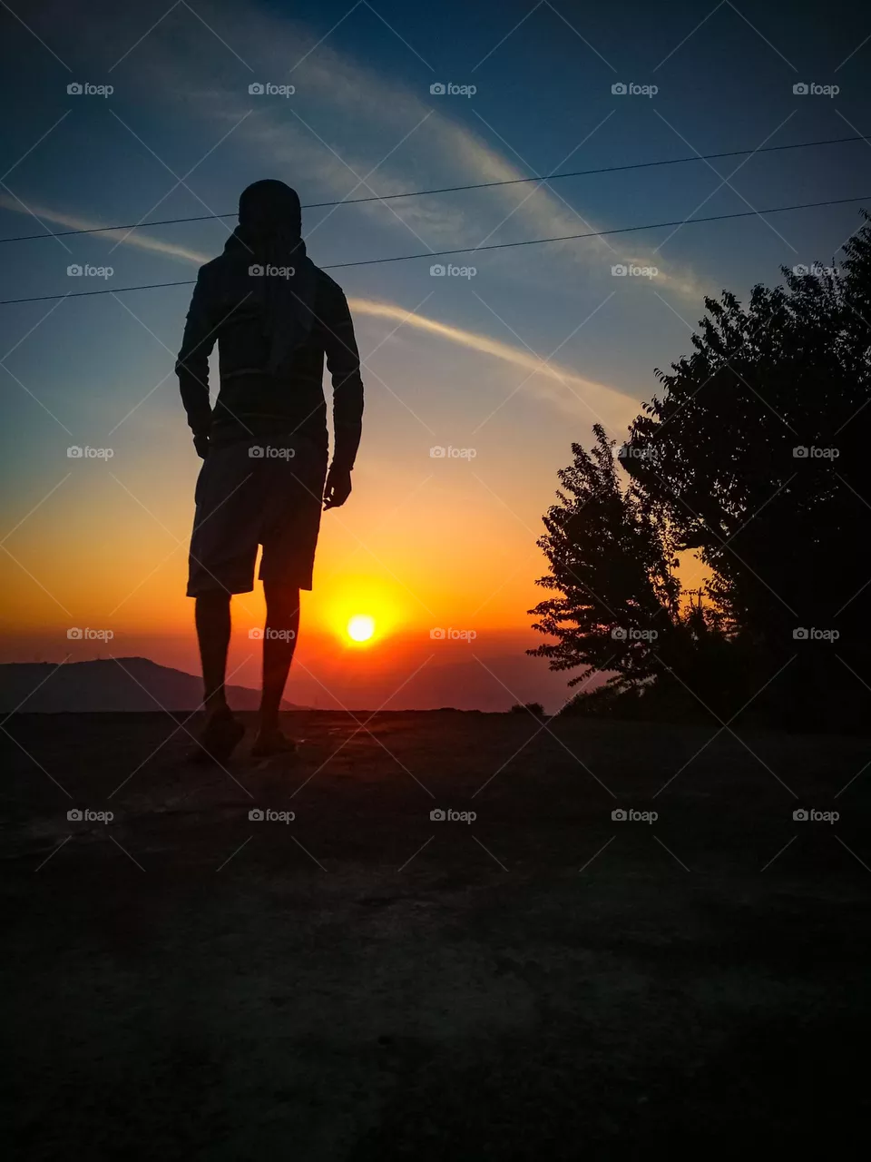 a man standing during the sunset.