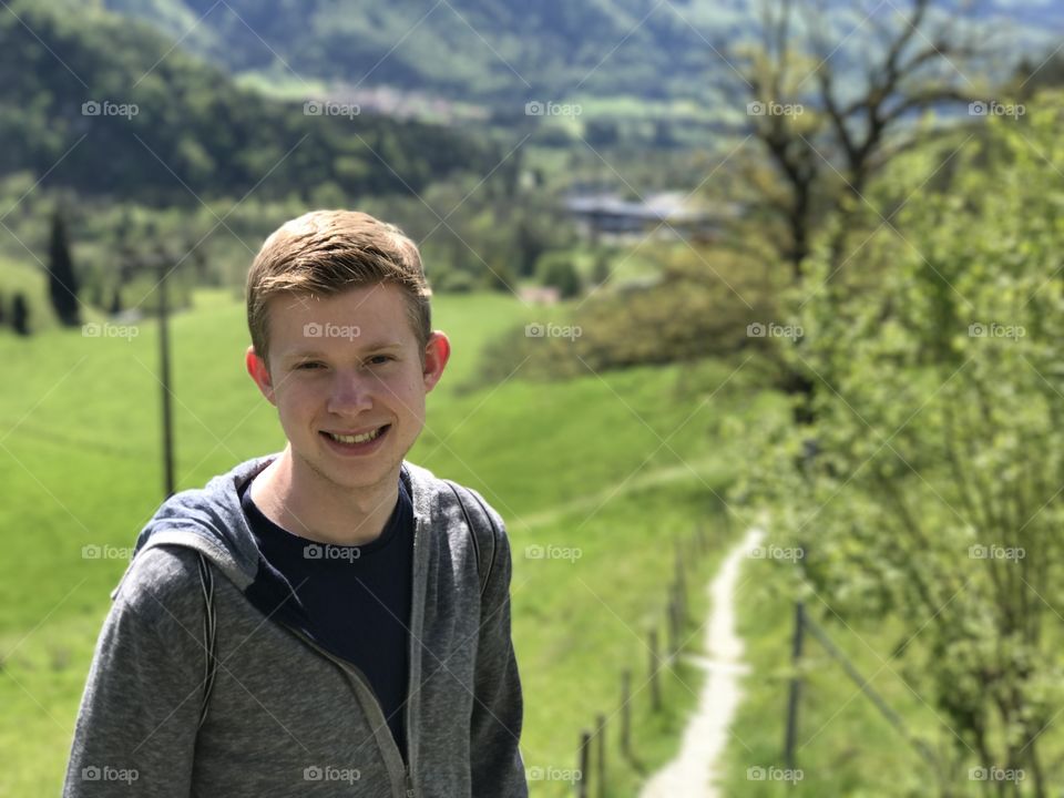 College student smiling for a photo in Gruyere, Switzerland. 