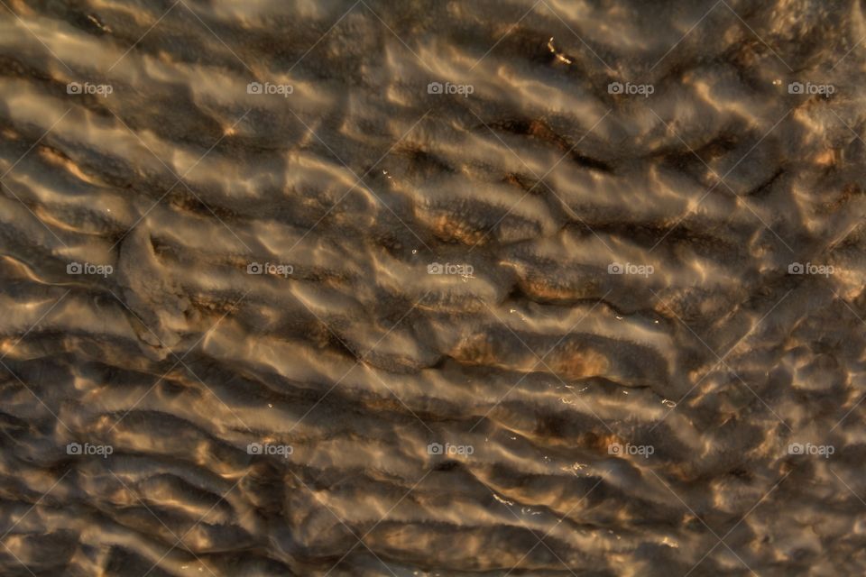 Water flowing over calcium deposits