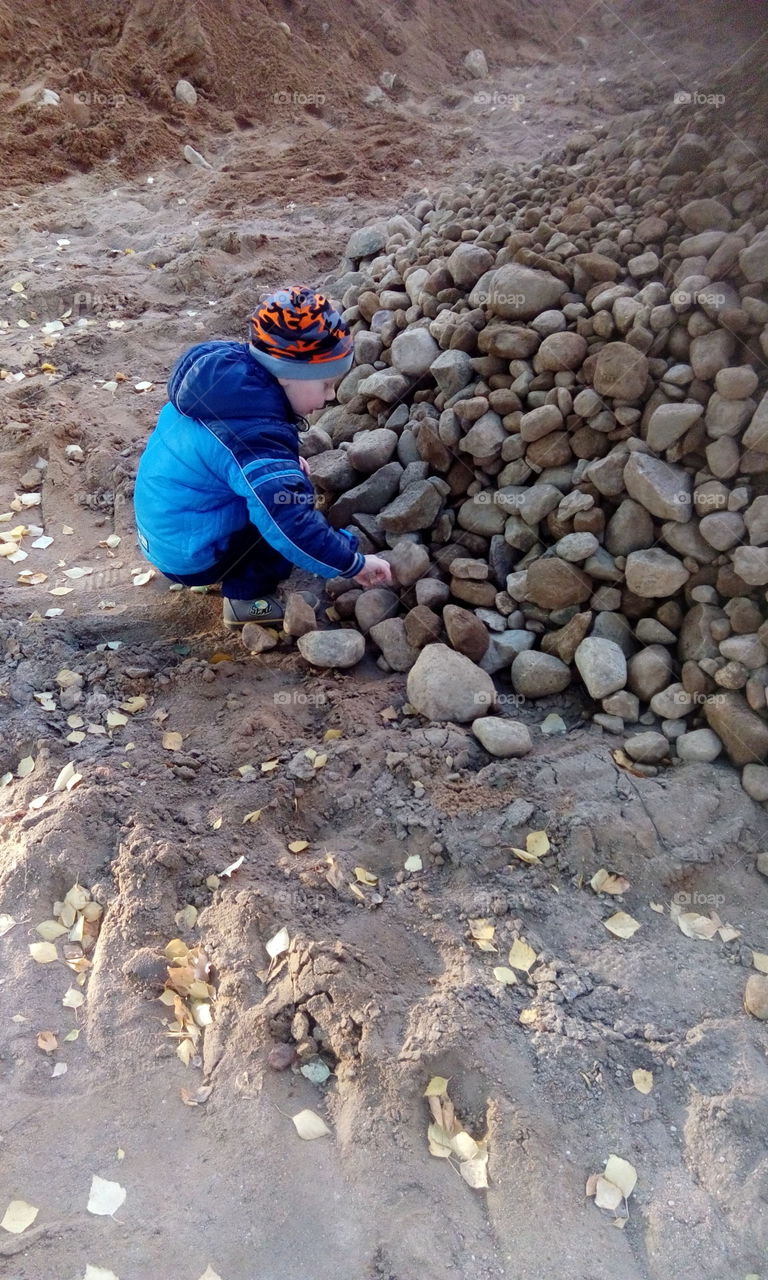 boy play with rocks