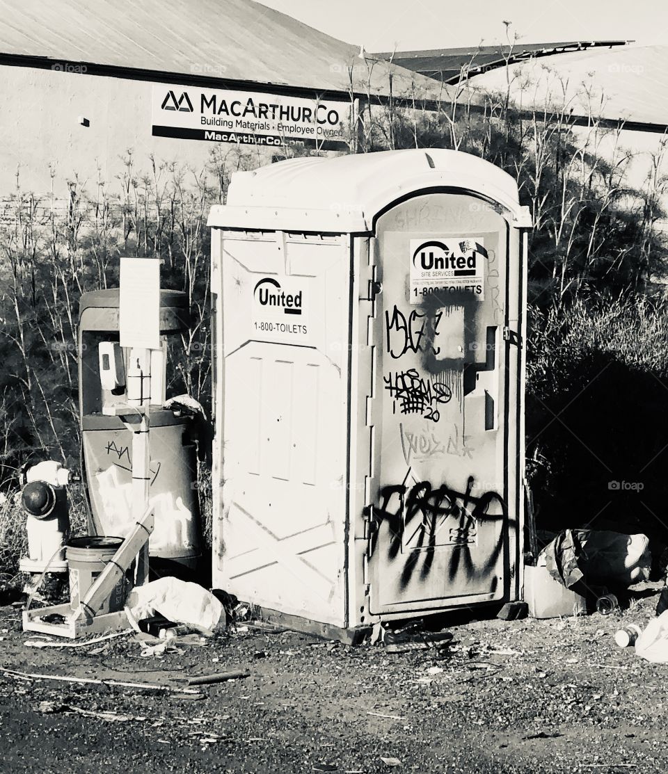 Port o potty,  that hasn’t been serviced in eons, out there by the city of Oakland and forgotten about BY the city of Oakland. In California.