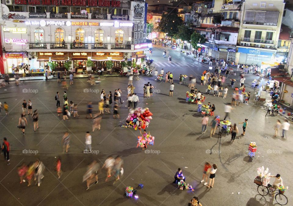 Busy crowd in the center of Hanoi with motion blur at night.