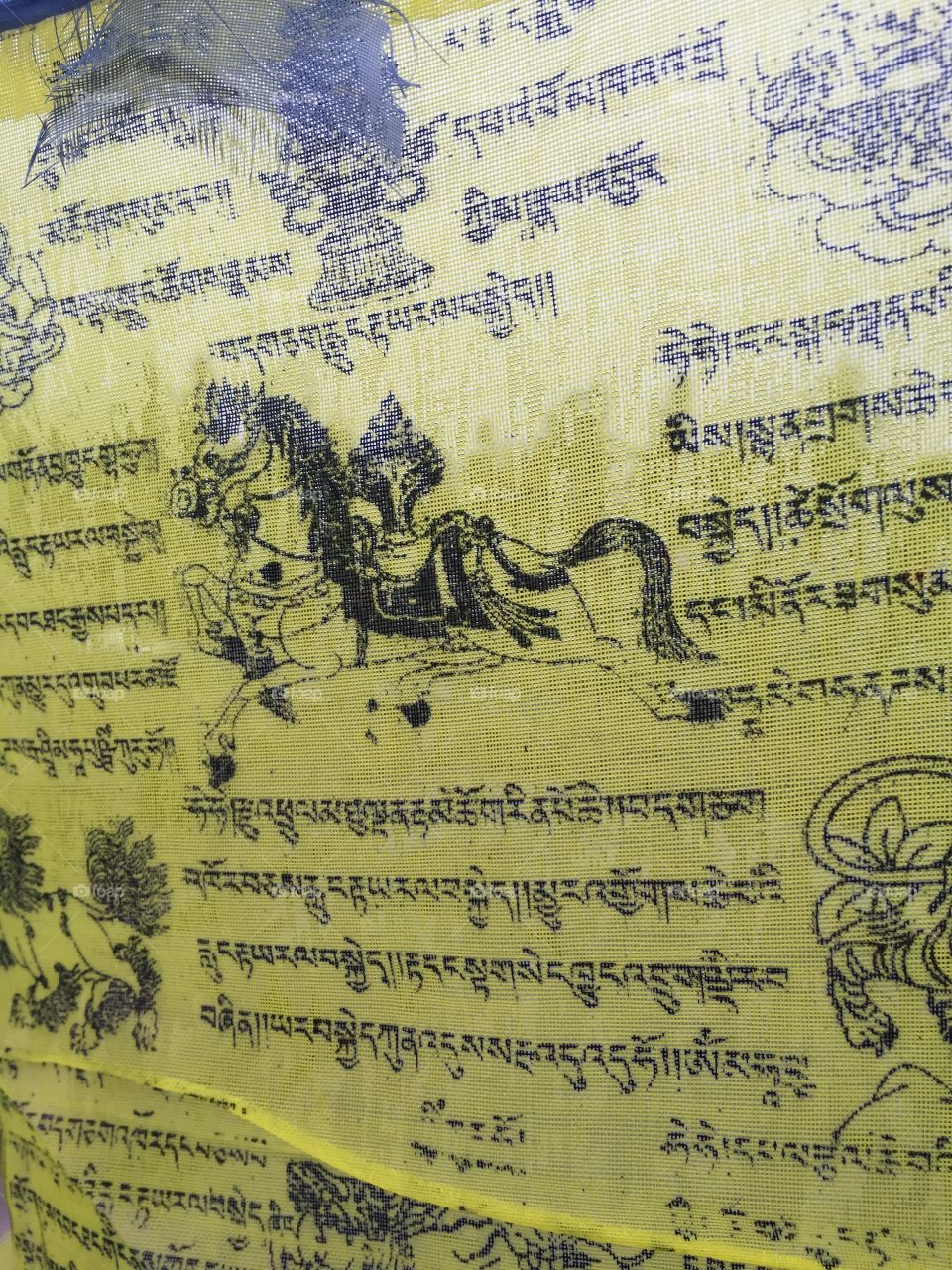 Yellow prayer flag. Close up of Tibetan prayer flag 