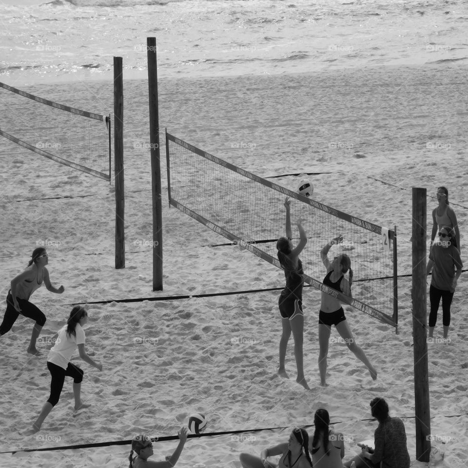 Spring breaker girls volleyball team play sand volleyball in front of the Gulf of Mexico! Action galore!