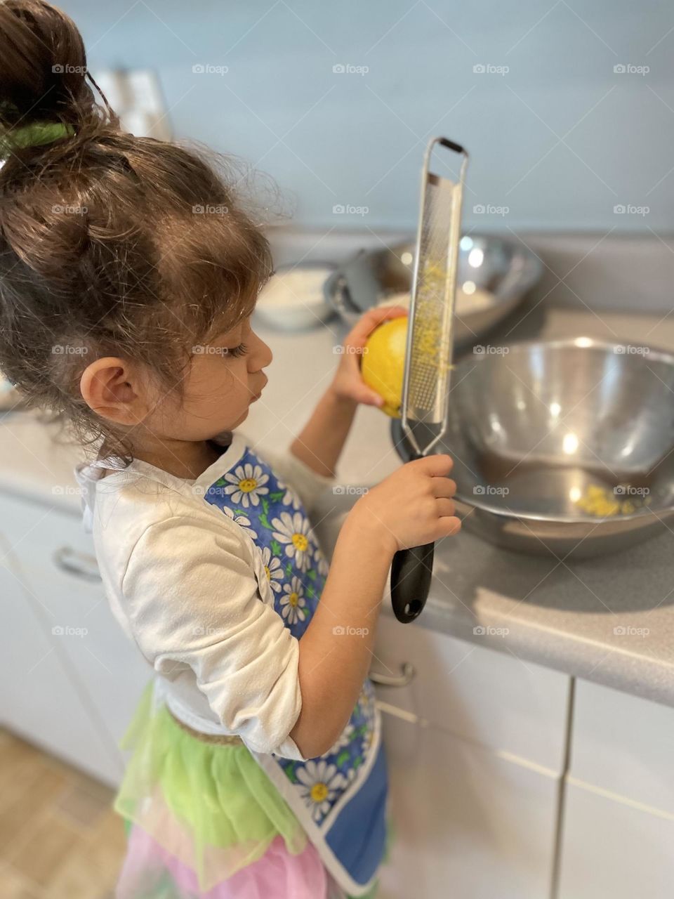 Toddler uses zester, toddler zesting a lemon, toddler helps mommy, helping mommy in the kitchen, baking with mommy 