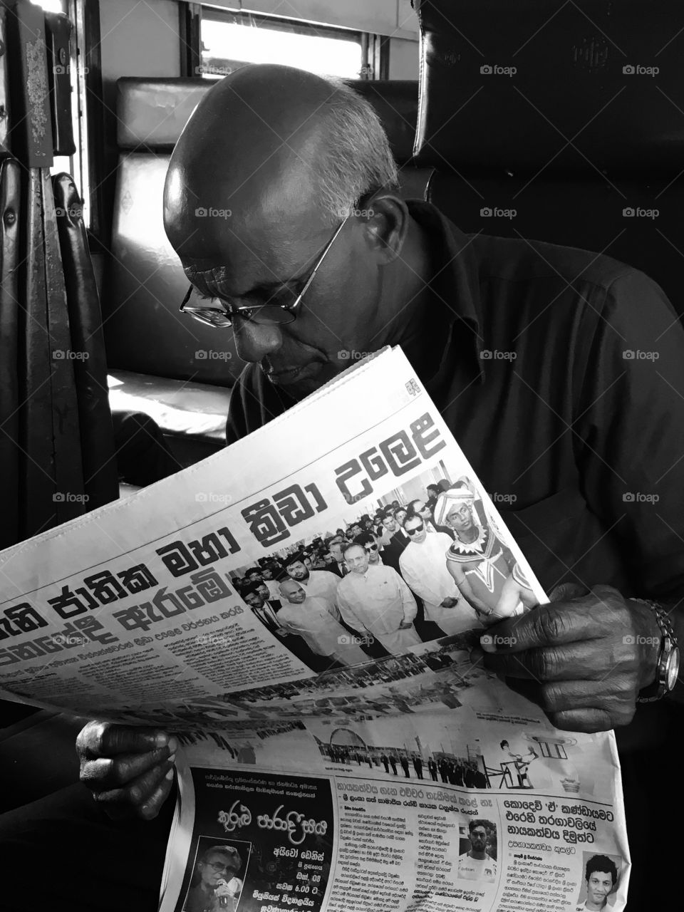 a matured man reading a newspaper