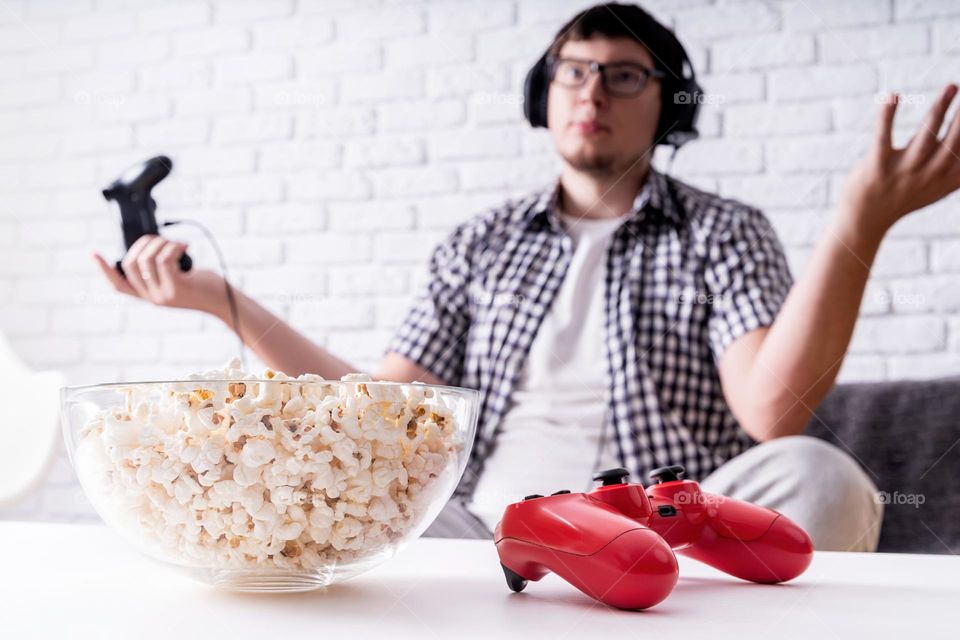 young emotional man playing video games