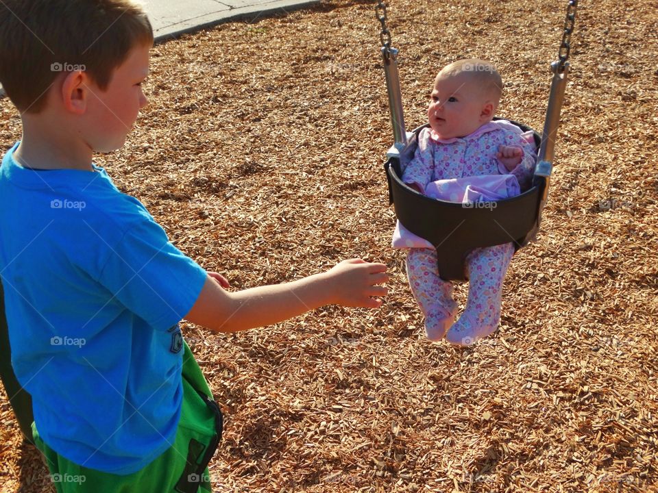 Pushing Baby On A Swingset